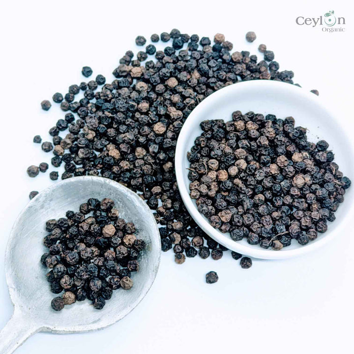 Black peppercorns, a popular spice used to add flavor and heat to dishes.