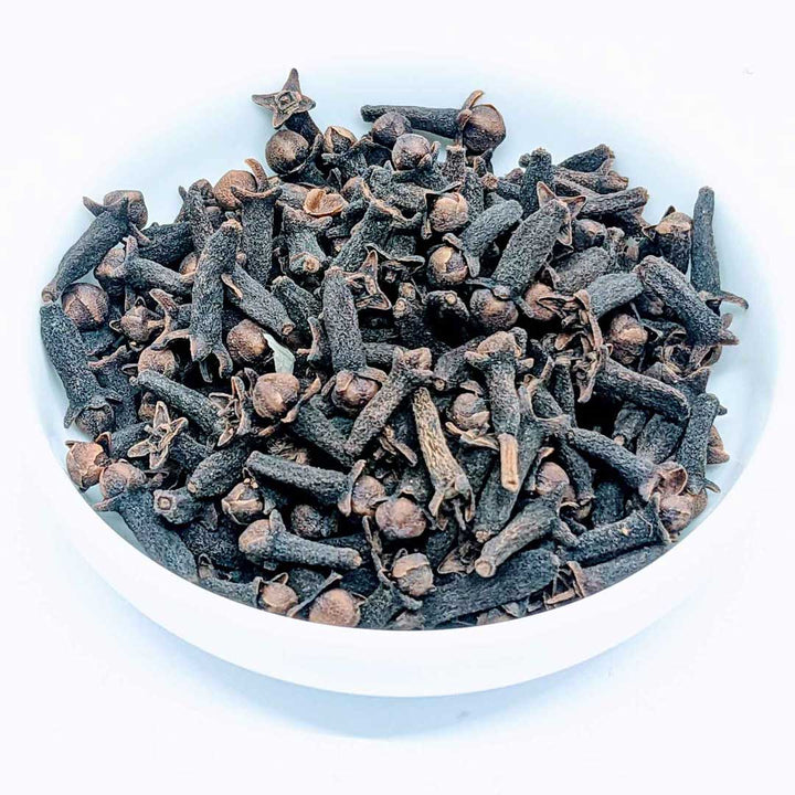 Top view of dried cloves in a spice bowl