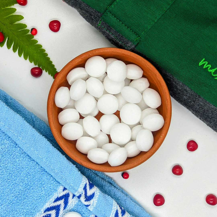  Close-up photo of a container of moth balls, used to protect clothing and fabrics against moths.