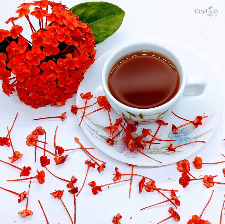 xora Coccinea flowers with herbal drink