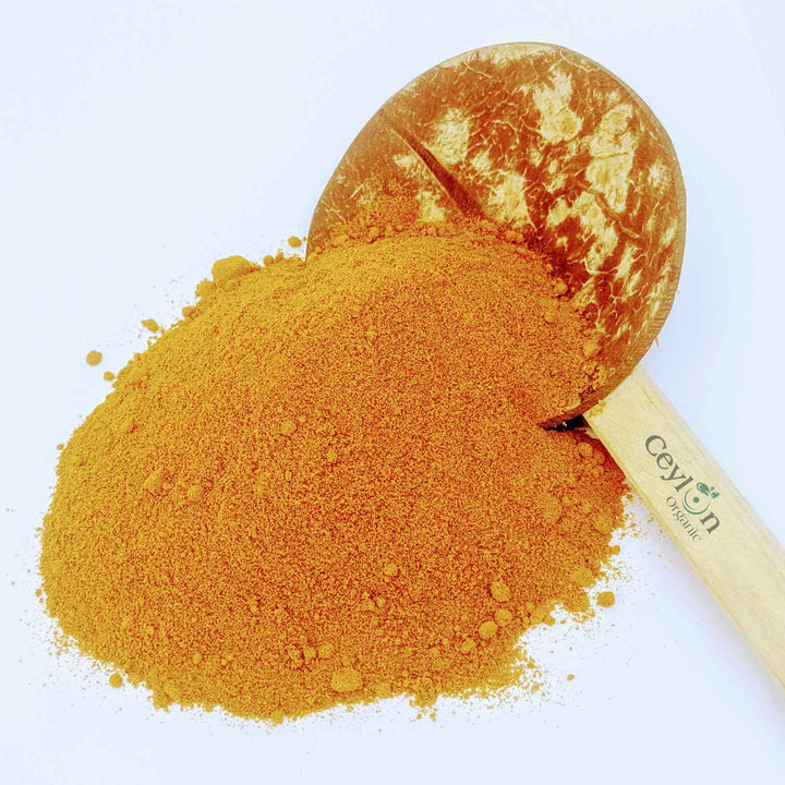 urmeric powder (Curcuma longa), a vibrant yellow spice with culinary and medicinal applications.